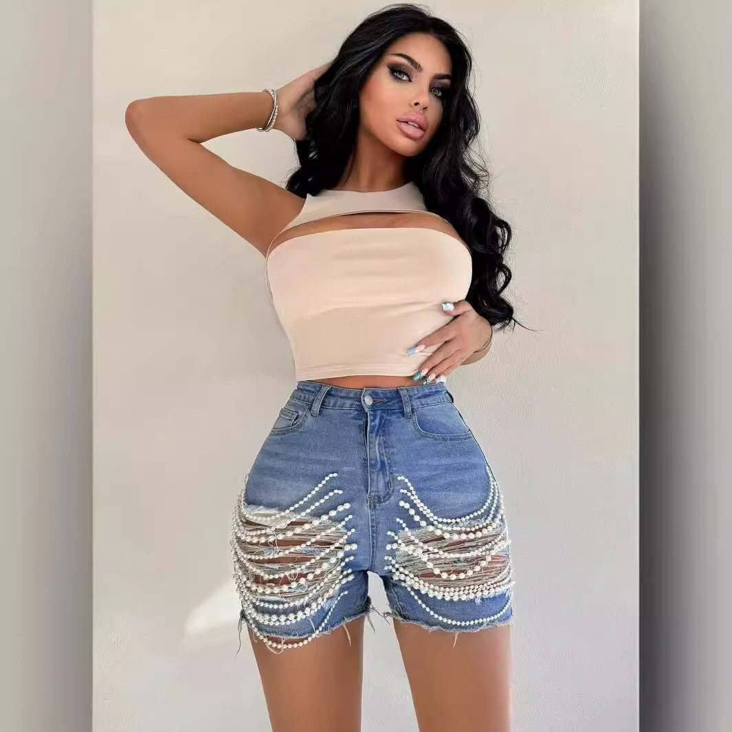 High waist denim shorts with pearl embellishments.